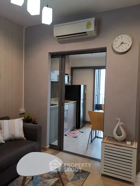 Modern living room with open kitchen and stylish decor in a cozy apartment.