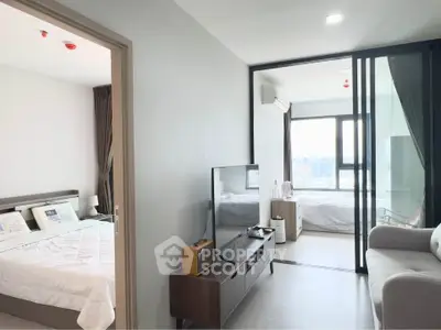 Modern apartment interior with spacious living room and bedroom, featuring sleek furniture and large windows.