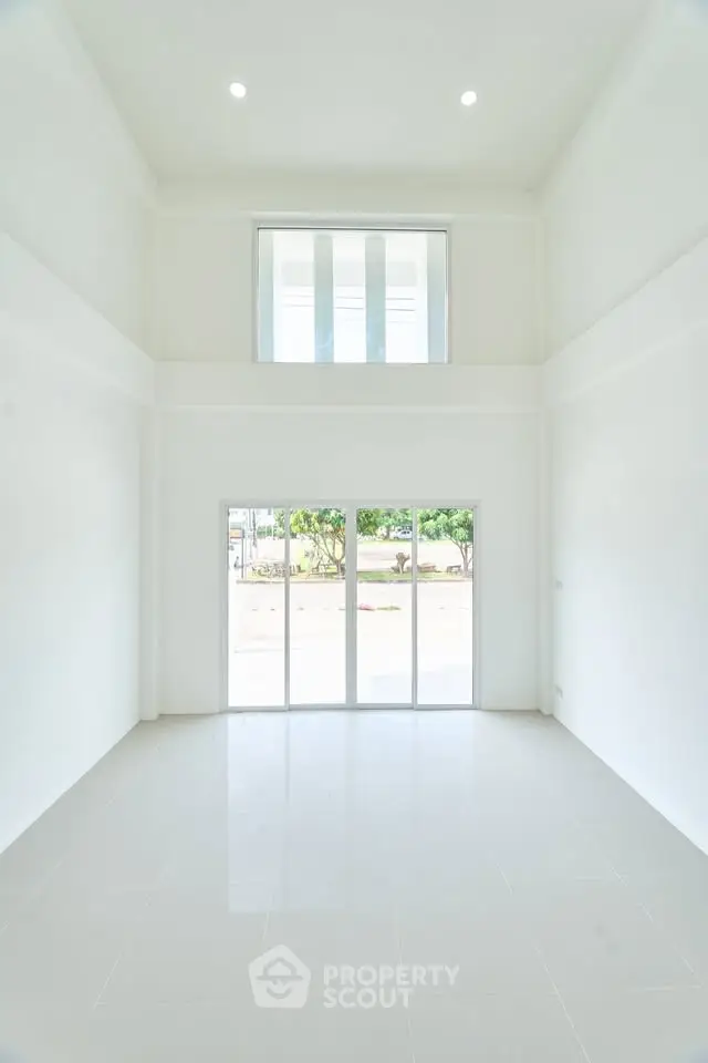 Spacious modern living room with high ceilings and large windows