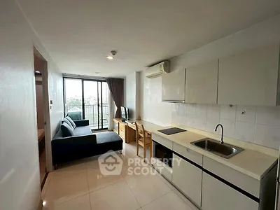 Modern open-layout living room with kitchen and balcony view