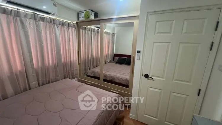 Cozy bedroom with mirrored wardrobe and soft lighting