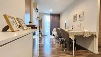 Modern living room with stylish decor and hardwood floors in a cozy apartment setting.