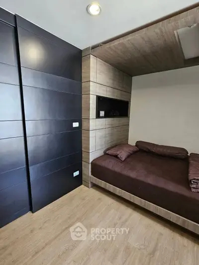 Modern bedroom with sleek design and wooden flooring