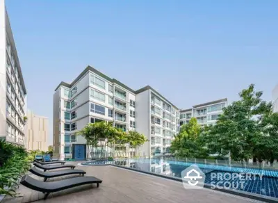 Modern apartment complex with pool and lush greenery, ideal for luxury urban living.