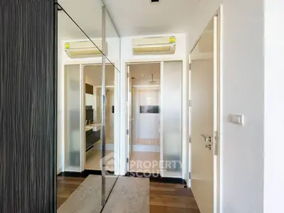 Modern apartment hallway with mirrored closet and air conditioning
