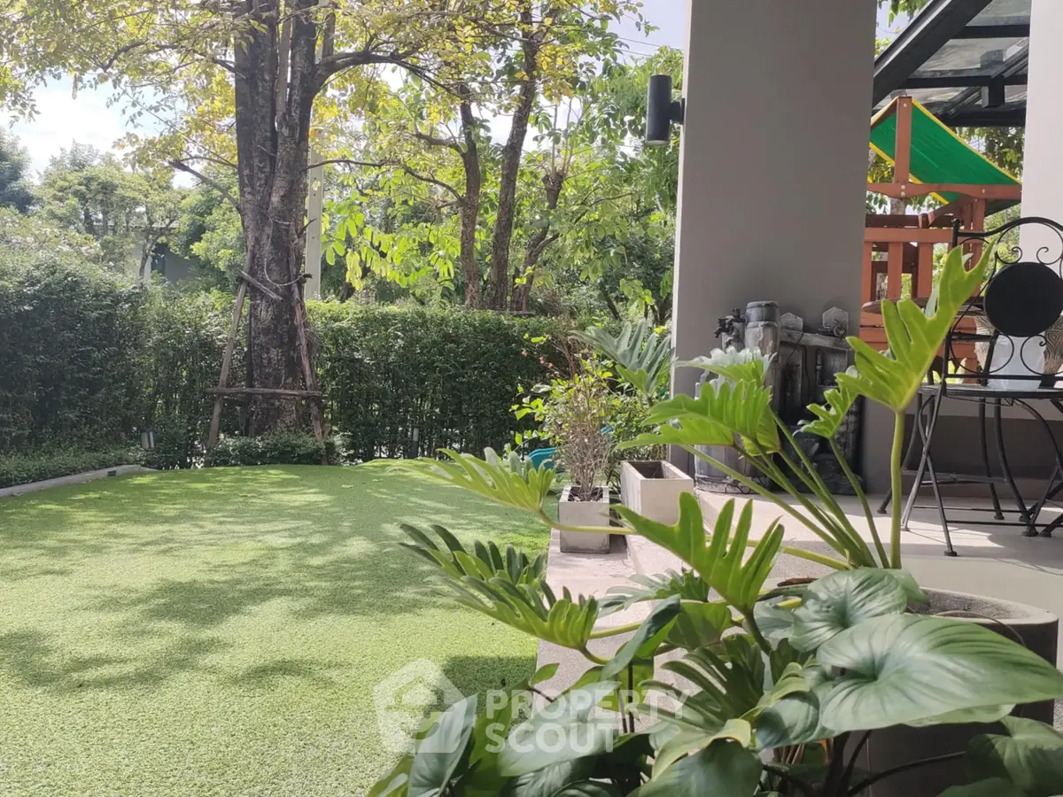 Charming garden view with lush greenery and cozy patio area, perfect for relaxation and outdoor enjoyment.