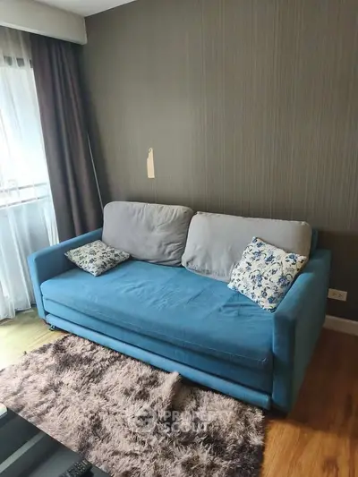 Cozy living room with blue sofa and stylish decor in modern apartment