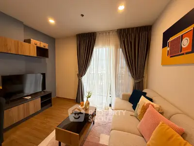 Modern living room with stylish decor and large window, featuring cozy seating and entertainment center.