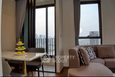 Modern living room with city view, featuring stylish furniture and elegant decor in a high-rise apartment.