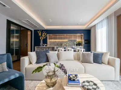 Luxurious modern living room with elegant decor and open kitchen layout, perfect for stylish urban living.