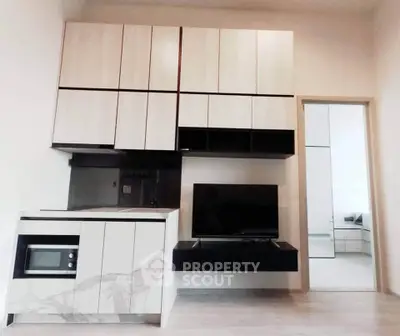 Modern kitchen with sleek cabinetry and integrated appliances in a stylish apartment.