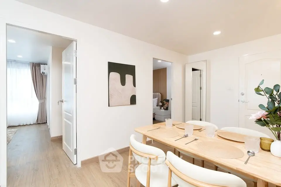 Modern dining area with elegant decor and natural light in a stylish apartment.