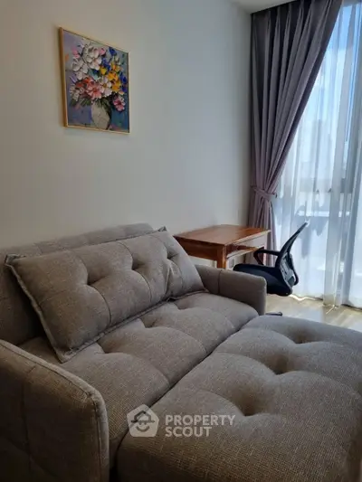 Cozy living room with modern sofa and natural light from large window