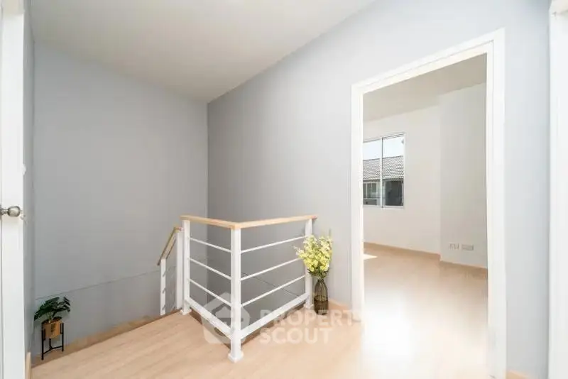 Bright and airy hallway with modern railing and natural light