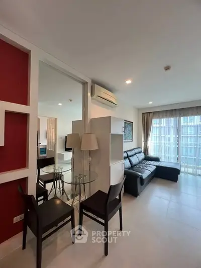 Modern living room with stylish furniture and large windows in a contemporary apartment.