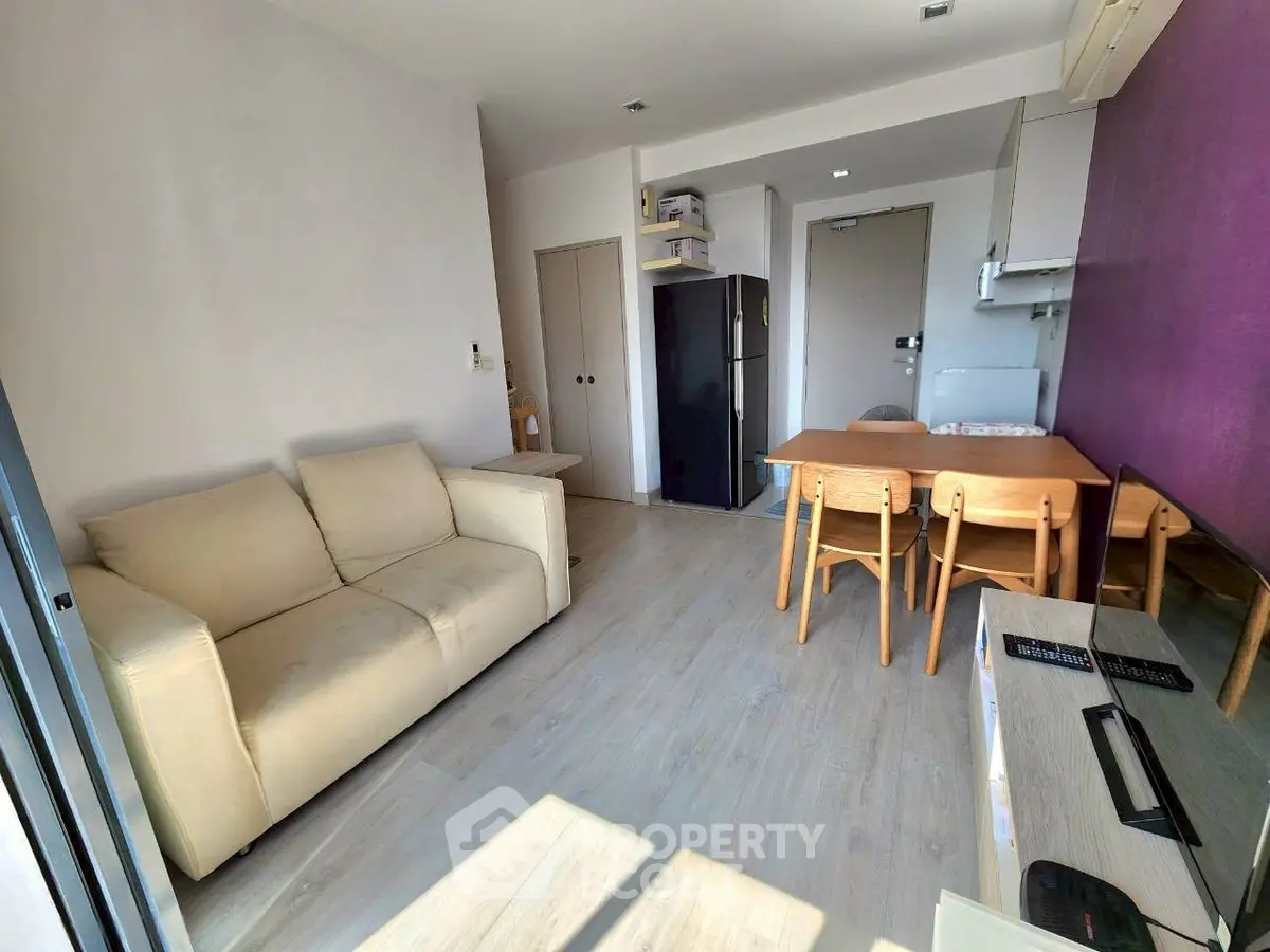 Bright modern living room with cozy sofa and dining area