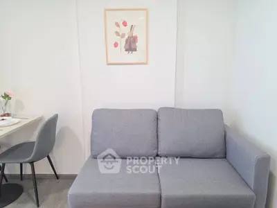 Cozy living room with modern gray sofa and minimalist decor