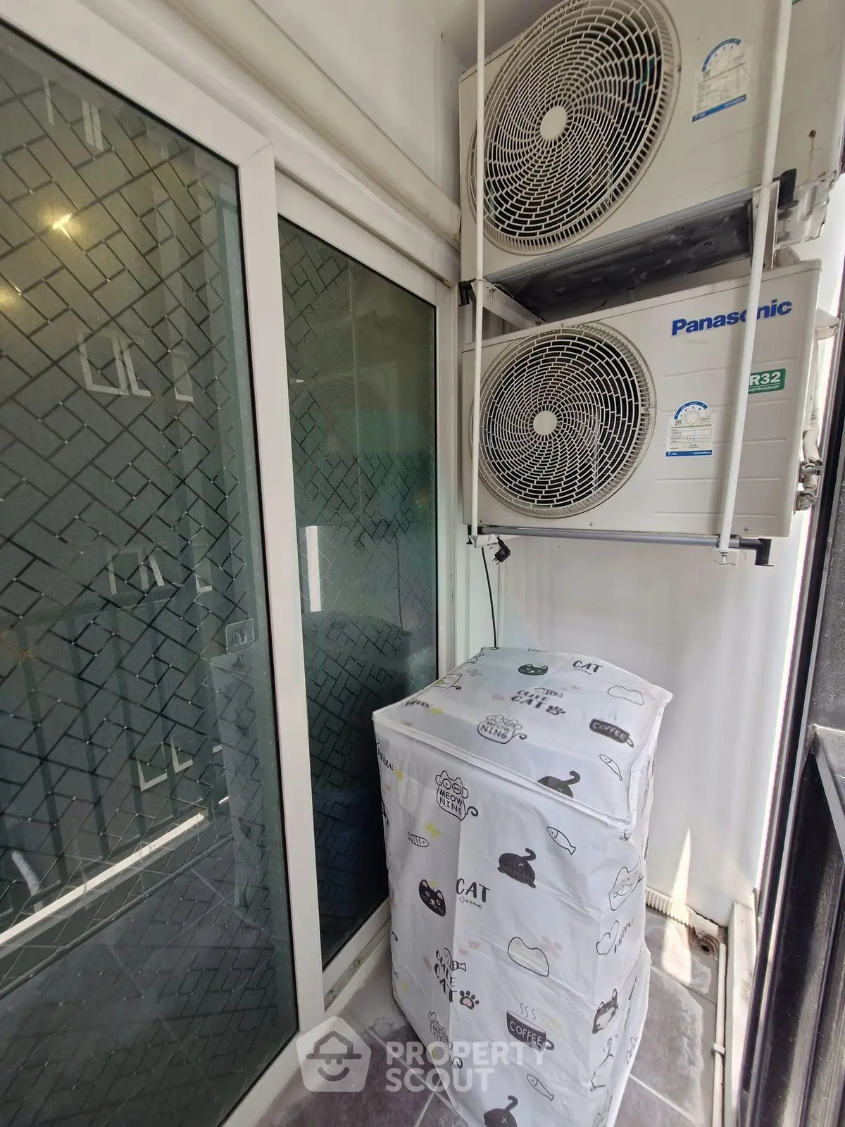 Compact balcony with air conditioning units and stylish cover, perfect for urban living.