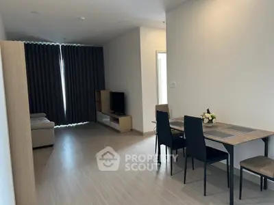 Spacious modern living room with dining area and sleek furniture in a contemporary apartment.