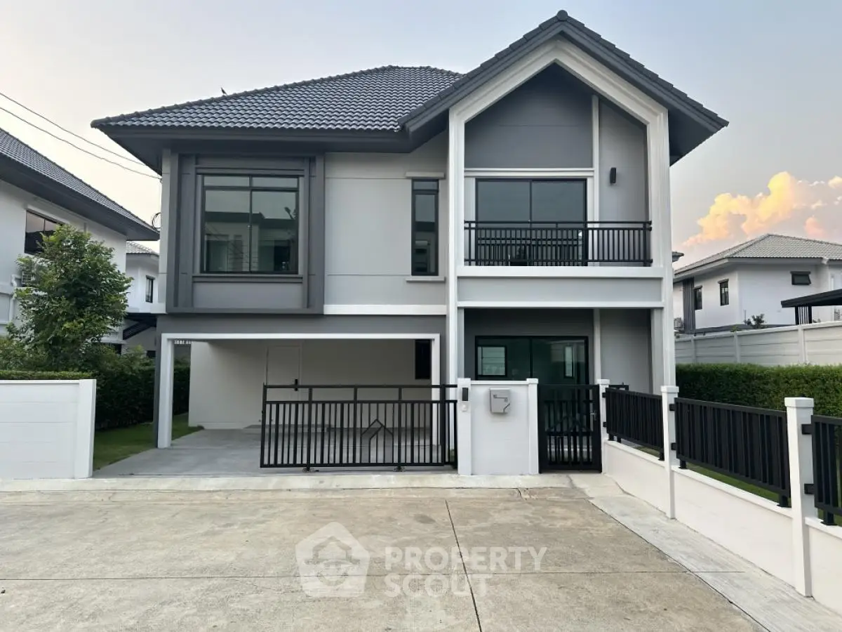 Modern two-story house with sleek design and spacious driveway in a serene neighborhood.