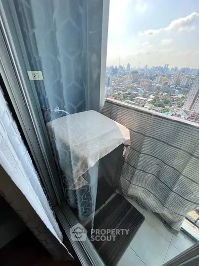 High-rise balcony with city view and washing machine, perfect for urban living.
