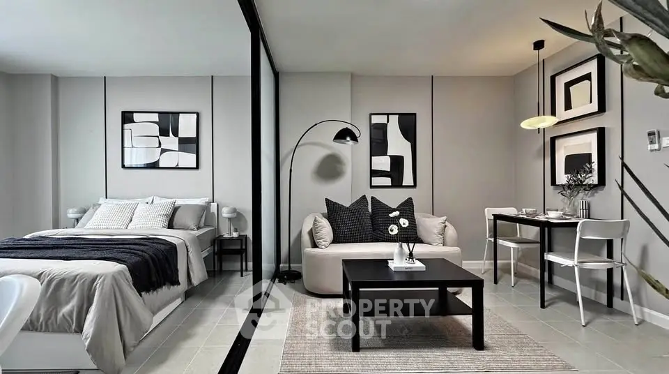 Modern studio apartment with stylish decor, featuring a cozy living area and elegant bedroom.