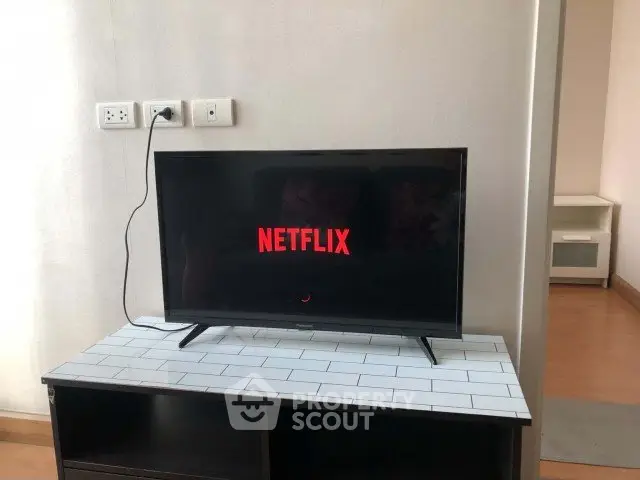 Modern living room with sleek TV setup on stylish console, perfect for entertainment.