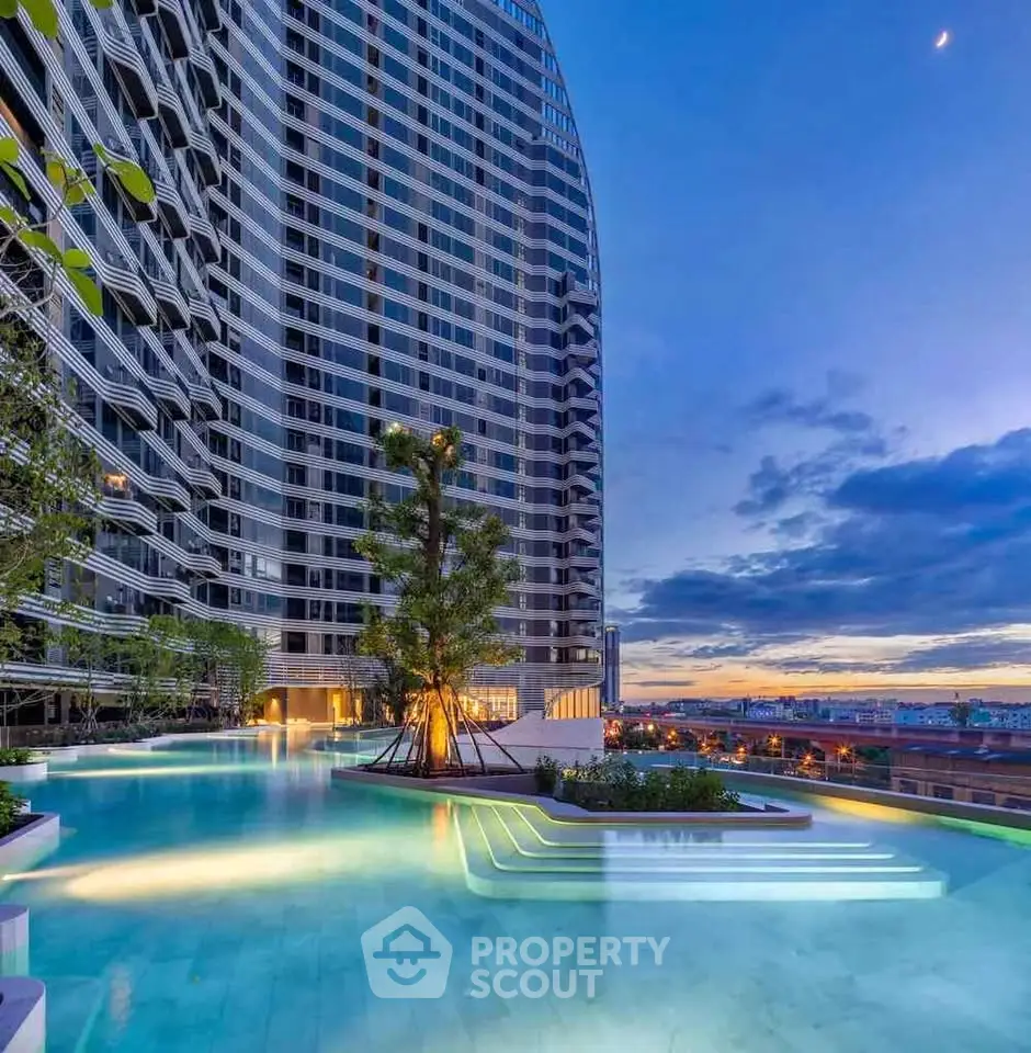 Luxurious high-rise building with stunning rooftop pool and breathtaking sunset view.