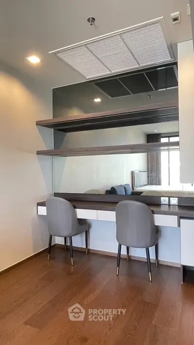 Modern study room with sleek wooden flooring and stylish chairs, perfect for productivity and comfort.