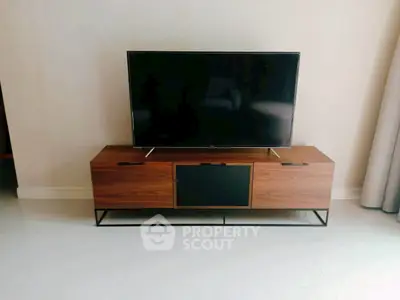 Modern living room with sleek TV stand and flat-screen television, perfect for entertainment setup.
