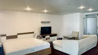 Spacious modern bedroom with elegant furniture and TV setup