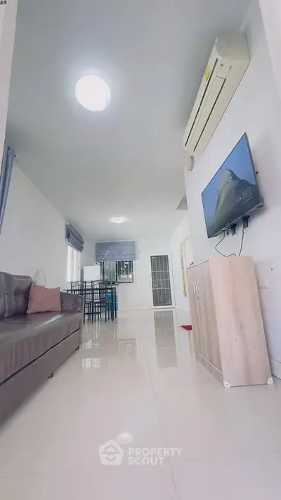 Spacious modern living room with sleek design and air conditioning
