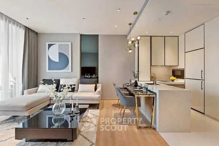 Modern open-plan living room and kitchen with elegant decor and natural light.