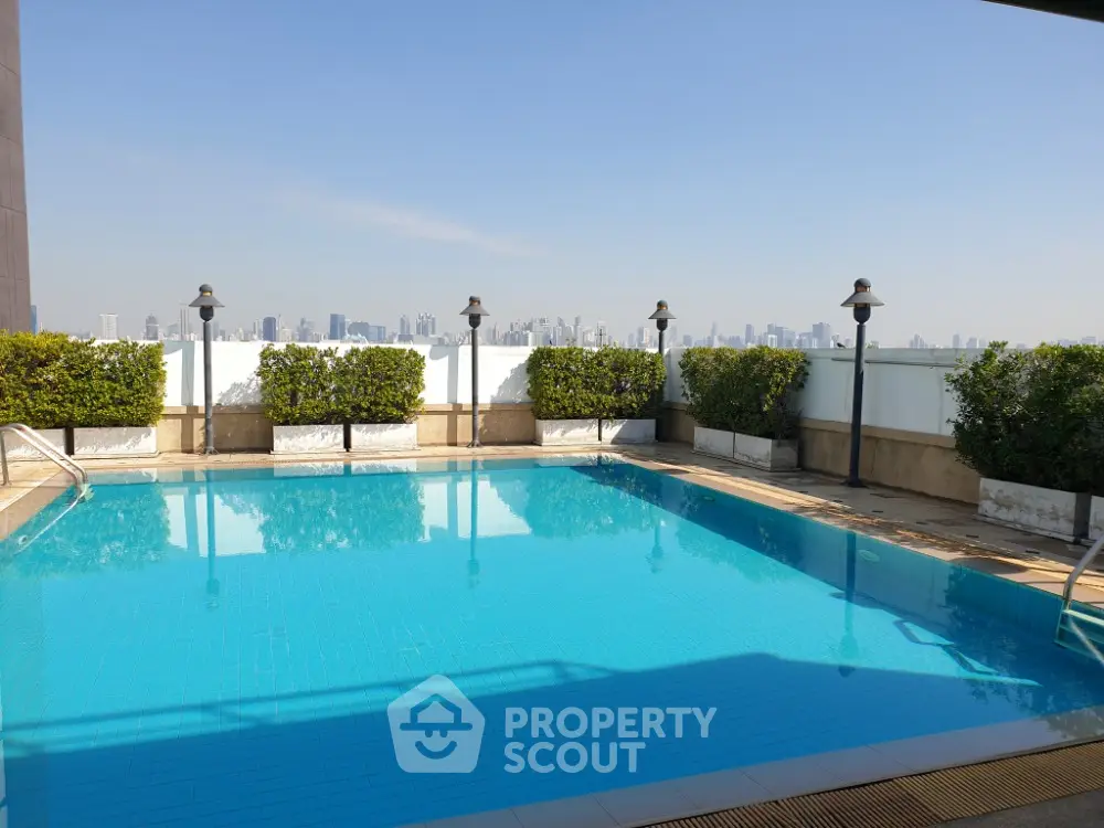 Stunning rooftop pool with city skyline view, perfect for relaxation and leisure.