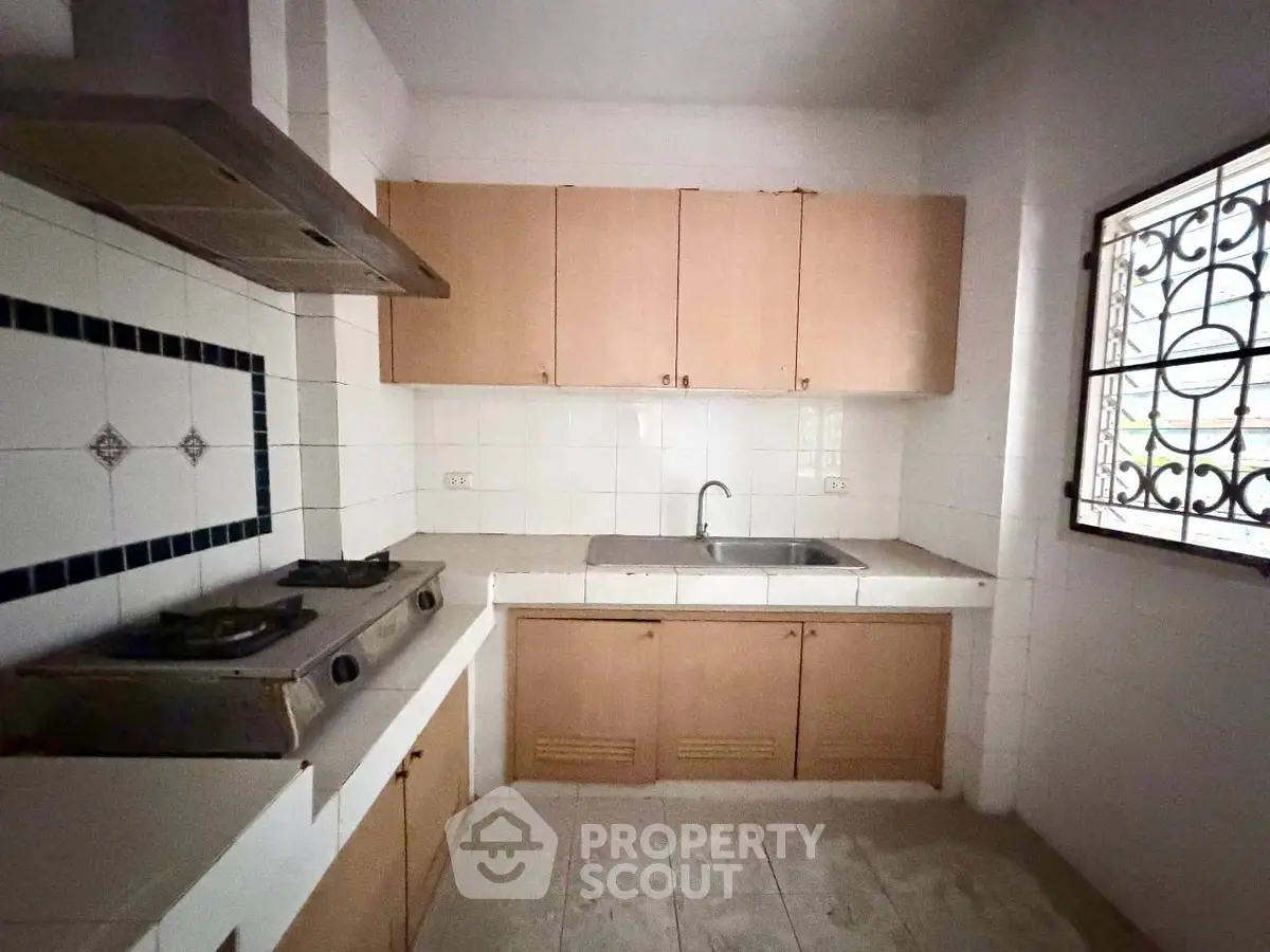Cozy kitchen with gas stove and ample cabinetry in a compact layout.