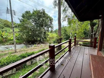 Charming wooden balcony with scenic nature view, perfect for relaxation and enjoying the outdoors.