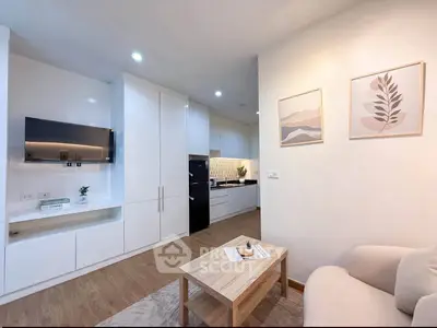 Modern living room with sleek kitchen, cozy seating, and stylish decor in a contemporary apartment.