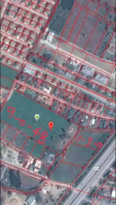 Aerial view of property plots with red boundary lines and plot numbers.