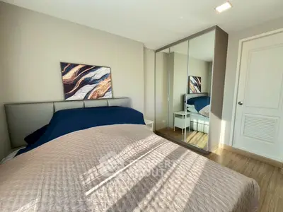 Cozy bedroom with mirrored wardrobe and stylish decor