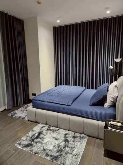 Luxurious bedroom with modern decor and plush bedding in a stylish apartment.