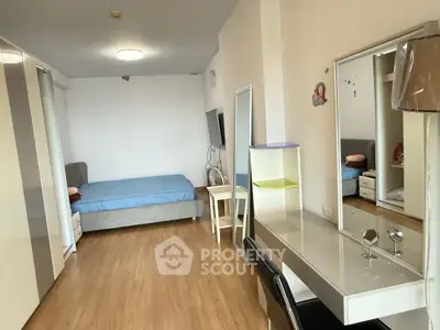 Spacious bedroom with modern decor and ample natural light