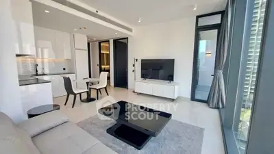 Modern living room with sleek furniture and large windows offering city views