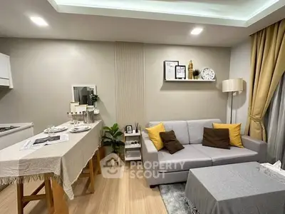 Modern living room with cozy sofa and stylish decor in open layout.