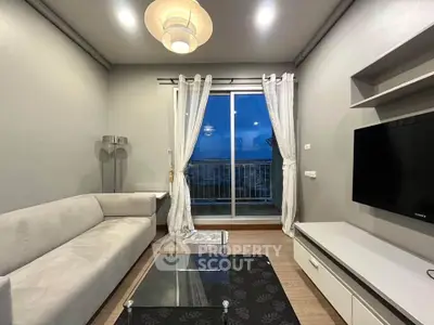 Modern living room with sleek furniture and balcony view, perfect for urban living.
