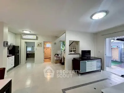 Spacious open-plan living area with modern furnishings and garden access
