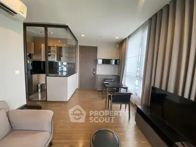 Modern living room with open kitchen and stylish decor in a contemporary apartment.