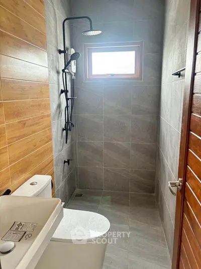 Modern bathroom with sleek shower and wooden accents