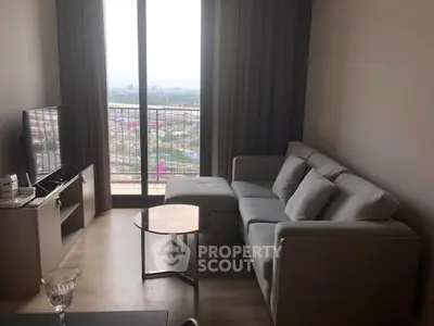 Modern living room with cozy sofa and stunning city view from large window.