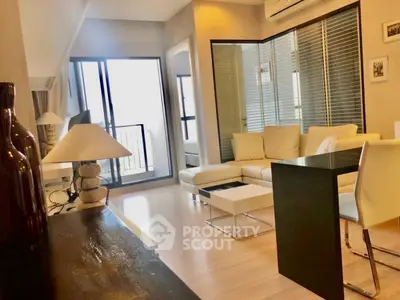 Modern living room with sleek furniture and balcony access in stylish apartment.