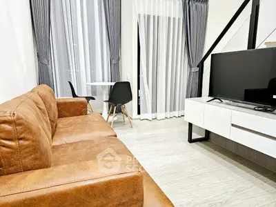 Modern living room with brown leather sofa and sleek TV setup